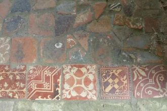 A biscuit tin secret comes to light as a former thief returns medieval tiles after sixty years