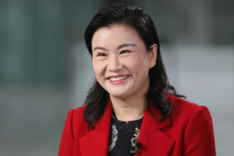 Meet Zhou Qunfei: Once she worked in a glass factory, now she runs a $26 billion company and sits alongside Elon Musk and Tim